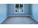 Carpeted bedroom featuring a view of the shed in the backyard, with ample natural light at 357 Riverwood Dr, Clayton, NC 27527