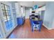 An open kitchen with wooden floors, white cabinets, and blue island with seating at 357 Riverwood Dr, Clayton, NC 27527
