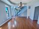 Living room with hardwood floors, an elegant chandelier, and staircase at 357 Riverwood Dr, Clayton, NC 27527