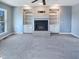 Living Room with carpeted floors, built-in shelves, fireplace, and ceiling fan at 357 Riverwood Dr, Clayton, NC 27527