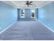 Spacious main bedroom featuring tray ceilings, a ceiling fan, carpet floors and bright windows at 357 Riverwood Dr, Clayton, NC 27527