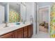 Bathroom features a double vanity with wood cabinets, a mirror and a shower/tub combo at 3601 Tartancroft Pl, Fuquay Varina, NC 27526
