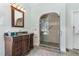 Bathroom features a walk-in shower with tile surround, vanity with granite countertop, and decorative mirror at 3601 Tartancroft Pl, Fuquay Varina, NC 27526