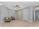 Spacious bedroom features carpet, ceiling fan, sitting area, and ensuite bathroom at 3601 Tartancroft Pl, Fuquay Varina, NC 27526