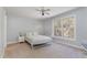 Bedroom featuring a white metal frame bed, a large window and neutral carpet at 3601 Tartancroft Pl, Fuquay Varina, NC 27526