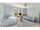 Shared bedroom features two beds, a desk, carpet, and a ceiling fan at 3601 Tartancroft Pl, Fuquay Varina, NC 27526
