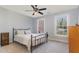 Cozy bedroom featuring carpet, ceiling fan, and two windows with natural light at 3601 Tartancroft Pl, Fuquay Varina, NC 27526