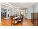 Elegant dining area featuring a large table, bay window, chandelier, and beautiful hardwood floors at 3601 Tartancroft Pl, Fuquay Varina, NC 27526