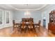 Elegant dining room with a large wooden table, chandelier, and hardwood floors at 3601 Tartancroft Pl, Fuquay Varina, NC 27526