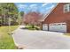 Long driveway leading to a brick house with an attached garage and a basketball hoop at 3601 Tartancroft Pl, Fuquay Varina, NC 27526