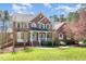 Lovely two-story brick home with a welcoming front porch and manicured landscaping, perfect for families at 3601 Tartancroft Pl, Fuquay Varina, NC 27526