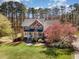 Charming brick home with blue shutters, lush lawn, and mature trees showcasing curb appeal at 3601 Tartancroft Pl, Fuquay Varina, NC 27526