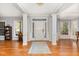 Spacious foyer with gleaming hardwood floors, decorative columns, and natural light creating a luxurious feel at 3601 Tartancroft Pl, Fuquay Varina, NC 27526