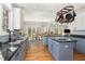 Bright kitchen with granite counters, stainless appliances, large island, and a view into the dining area at 3601 Tartancroft Pl, Fuquay Varina, NC 27526