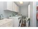 Efficient laundry room featuring white cabinets, a utility sink, a washer, and a dryer at 3601 Tartancroft Pl, Fuquay Varina, NC 27526