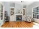 Cozy living room featuring built-in bookshelves, a fireplace, and natural light at 3601 Tartancroft Pl, Fuquay Varina, NC 27526
