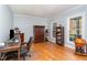 Bright home office featuring hardwood floors, large windows, and classic furniture at 3601 Tartancroft Pl, Fuquay Varina, NC 27526