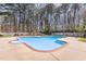 Backyard featuring a large in-ground pool surrounded by a concrete deck and surrounded by a tall privacy fence at 3601 Tartancroft Pl, Fuquay Varina, NC 27526
