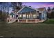 Beautiful backyard featuring a screened-in porch and an expansive lawn at 390 Lake Magnolia Way, Smithfield, NC 27577