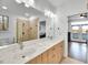 Bright bathroom with double vanity, stone countertops, and a tiled walk-in shower at 390 Lake Magnolia Way, Smithfield, NC 27577