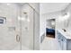Bright bathroom with a walk-in shower, vanity, and access to the main bedroom at 390 Lake Magnolia Way, Smithfield, NC 27577