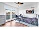 Comfortable bedroom with hardwood floors, a ceiling fan, and access to a balcony overlooking a scenic view at 390 Lake Magnolia Way, Smithfield, NC 27577