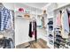Walk-in closet featuring custom shelving, hanging rods, and hardwood floors at 390 Lake Magnolia Way, Smithfield, NC 27577