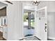 View of a bright entryway featuring a white door, stylish rug, and a glimpse of the porch at 390 Lake Magnolia Way, Smithfield, NC 27577