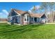 Well-maintained home with a lush green lawn, stone accents, a covered porch, and a large yard at 390 Lake Magnolia Way, Smithfield, NC 27577