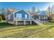 Stylish exterior of the home featuring a spacious deck and beautifully landscaped surroundings at 390 Lake Magnolia Way, Smithfield, NC 27577
