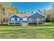 Charming exterior view of the home featuring a covered porch and well-manicured lawn at 390 Lake Magnolia Way, Smithfield, NC 27577