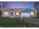 Charming single-story home featuring blue siding, a stone accent wall, well-maintained lawn, and inviting front porch at 390 Lake Magnolia Way, Smithfield, NC 27577