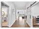 Hallway with hardwood floors leads to an open living area with natural light and neutral décor at 390 Lake Magnolia Way, Smithfield, NC 27577