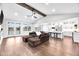 Open-concept living space featuring a vaulted ceiling, hardwood floors, and a kitchen island at 390 Lake Magnolia Way, Smithfield, NC 27577
