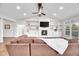 Inviting living room featuring a fireplace with built-in shelves and a comfortable brown sectional sofa at 390 Lake Magnolia Way, Smithfield, NC 27577