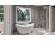 Bathroom with a freestanding tub and a window with nature views at 3908 Cedar Knolls Dr, Youngsville, NC 27596