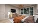 Relaxing bedroom featuring large window with forest views, a console, and wall-mounted television at 3908 Cedar Knolls Dr, Youngsville, NC 27596
