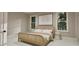 Airy bedroom featuring a woven headboard and bright natural light from two windows at 3908 Cedar Knolls Dr, Youngsville, NC 27596