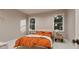 Modern bedroom with an orange comforter, bright windows, and light-colored carpet at 3908 Cedar Knolls Dr, Youngsville, NC 27596