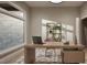 Bright home office features a large window, modern desk, and shelving for organization at 3908 Cedar Knolls Dr, Youngsville, NC 27596