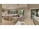 Open kitchen with seating, dining, and view to Gathering room; large windows allow for ample natural light at 3908 Cedar Knolls Dr, Youngsville, NC 27596