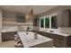 Modern kitchen featuring a large island with marble countertop, updated appliances, and an abundance of natural light at 3908 Cedar Knolls Dr, Youngsville, NC 27596