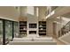 Open living room with a modern fireplace, custom built-ins, large windows and ample natural light at 3908 Cedar Knolls Dr, Youngsville, NC 27596
