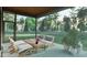Relaxing screened porch offers comfortable seating and views of the expansive backyard and wooded landscape at 3908 Cedar Knolls Dr, Youngsville, NC 27596