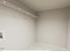 Laundry room featuring white walls, tile floor, and wire shelving for storage at 3922 Willow Gate Way, Raleigh, NC 27604