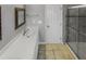 Bathroom featuring shower, glass shower doors, large mirror, large sink and vanity with white cabinets at 4216 High Mountain Dr, Raleigh, NC 27603