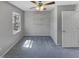 Bedroom featuring plush gray carpeting, a ceiling fan, one window, and a closet at 4216 High Mountain Dr, Raleigh, NC 27603