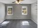 Bedroom featuring plush gray carpeting, a ceiling fan, and two large windows at 4216 High Mountain Dr, Raleigh, NC 27603