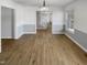 Bright dining room featuring hardwood floors, modern lighting, and staircase view at 4216 High Mountain Dr, Raleigh, NC 27603