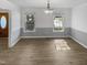 Dining room with wood flooring, modern light fixture, and views to the outside at 4216 High Mountain Dr, Raleigh, NC 27603